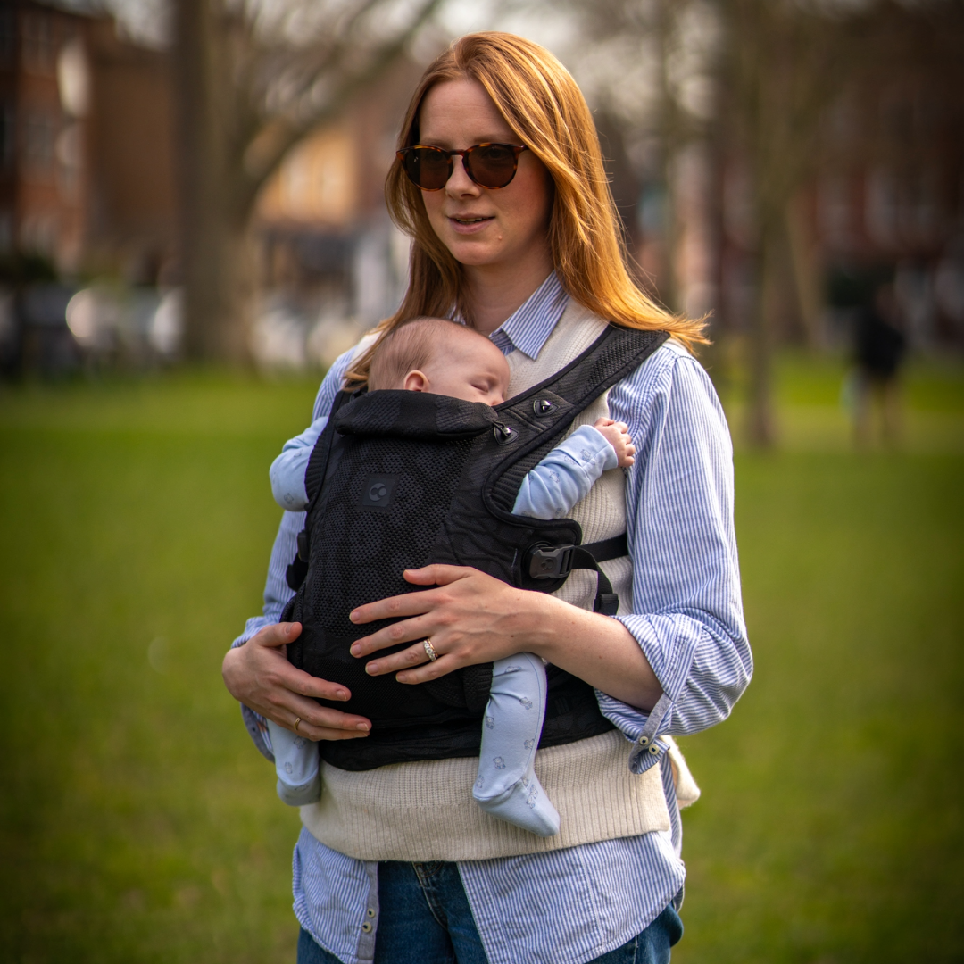 Breastfeeding mum wearing a baby carrier